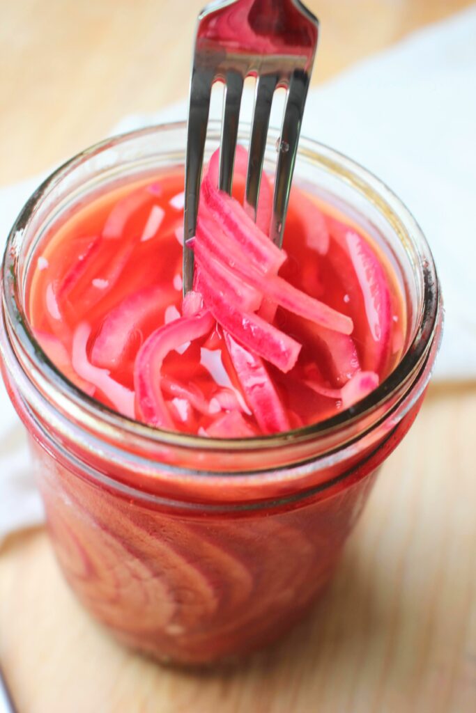 A fork full of pickled onions.