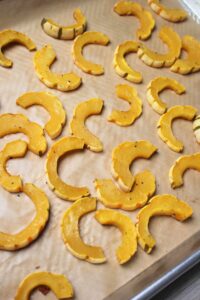 The roasted squash on the lined pan just came out of the oven.