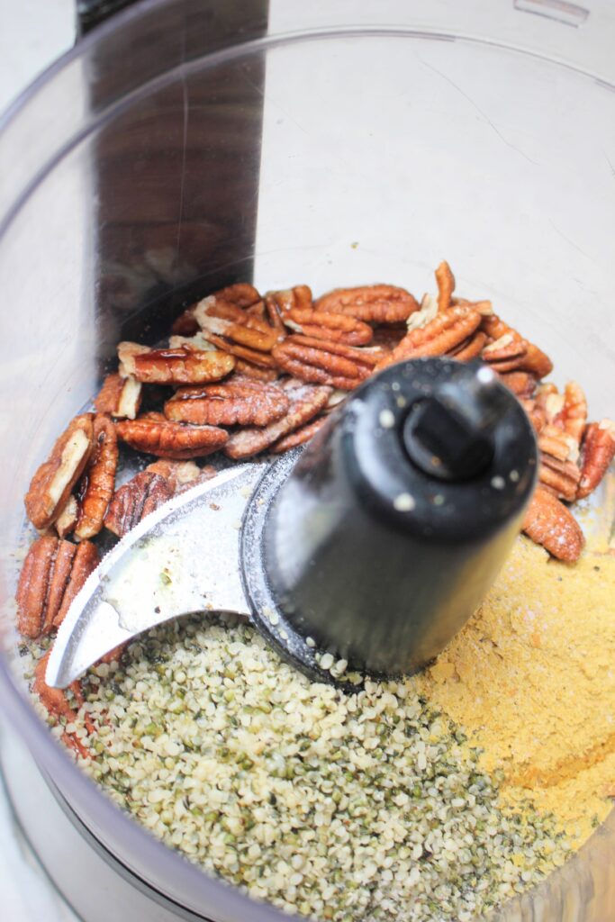 The ingredients in a food processor for the pecan parmesan. 