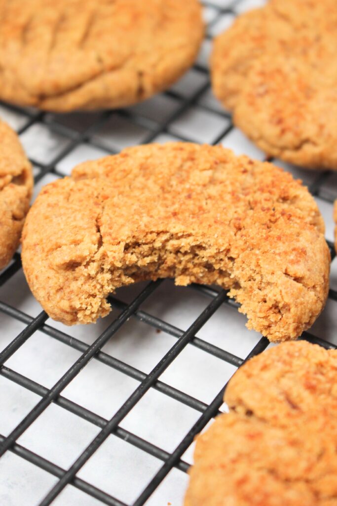 A bite out of these vegan peanut butter cookies.