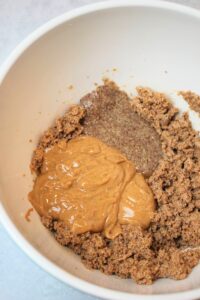 The peanut butter and flax egg have been added to a large bowl.