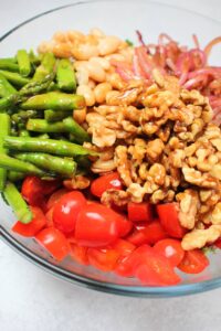 The dressing was poured onto the salad is is now ready to be tossed.