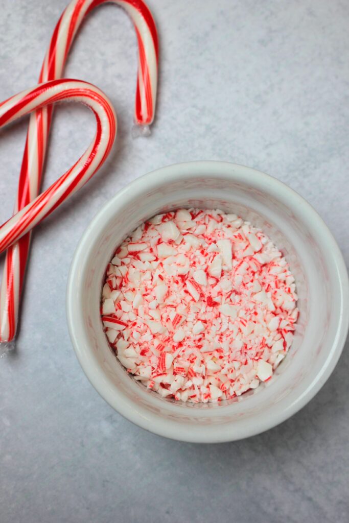 Crushed up candy cane in a small bowl.