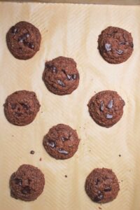 The cookies are on a baking sheet and just came out of the oven.