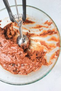 Using a cookie scoop to scoop out cookie dough balls.