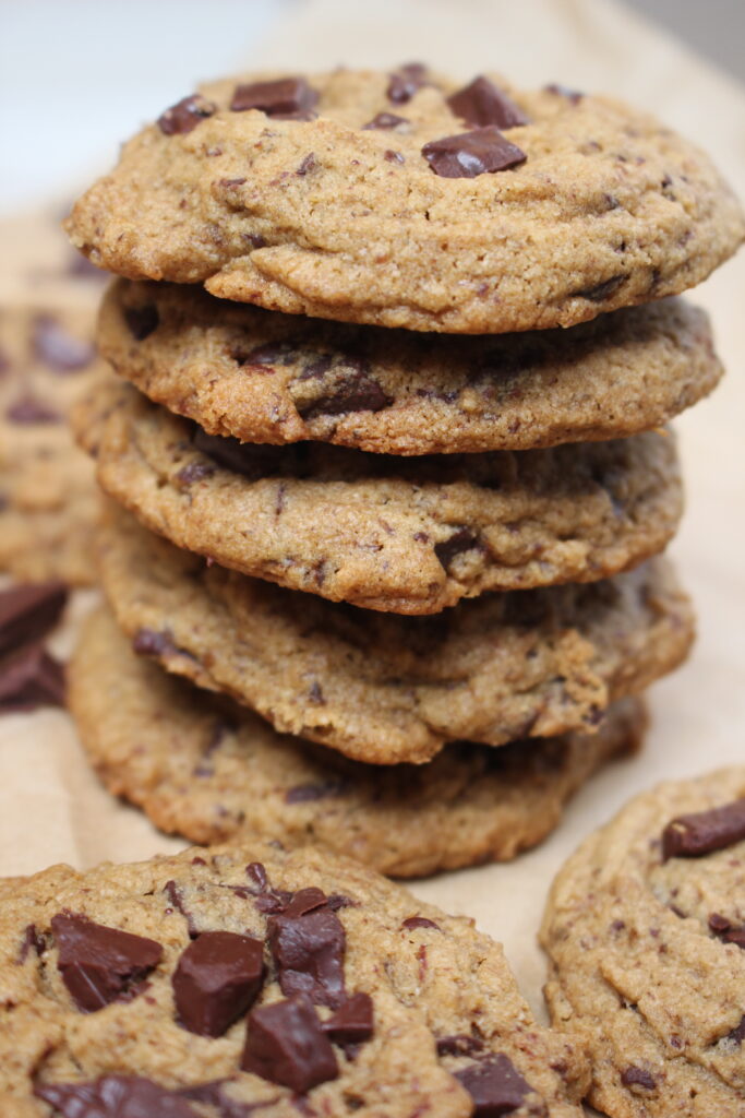 Vegan chocolate chip cookies stacked 5 high.