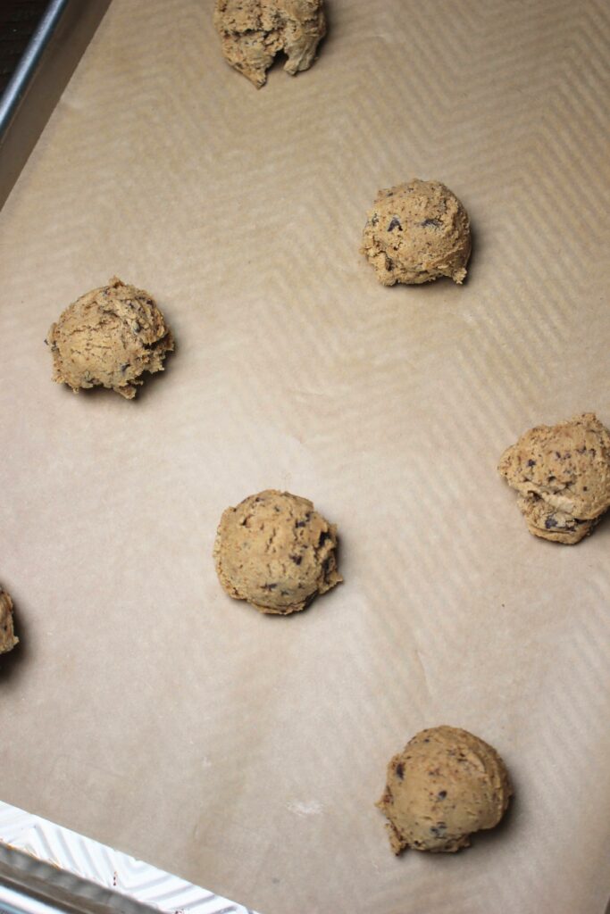 Cookie dough balls placed onto a cookie sheet and ready to bake.