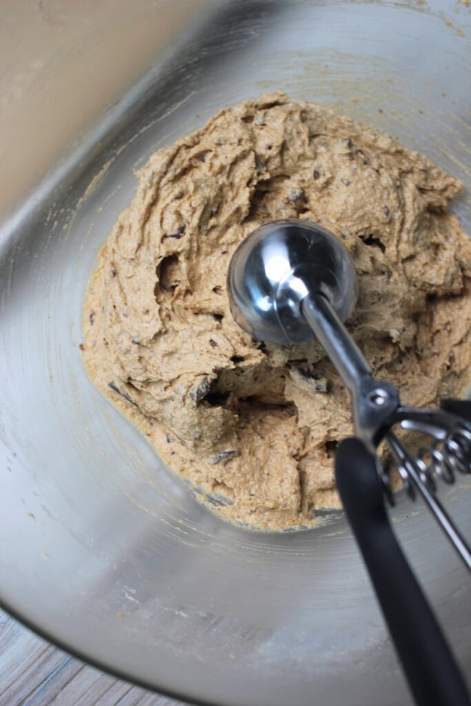 Scooping a ball of dough into a cookie scoop.