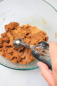 Scooping a ball of dough.