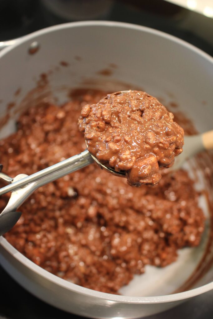 Scooping the wet mixture into a cookie scoop.