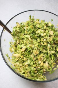 All of the slaw ingredients have been added to a bowl and tossed.