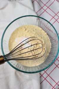 Whisking the dry ingredients in a glass bowl.