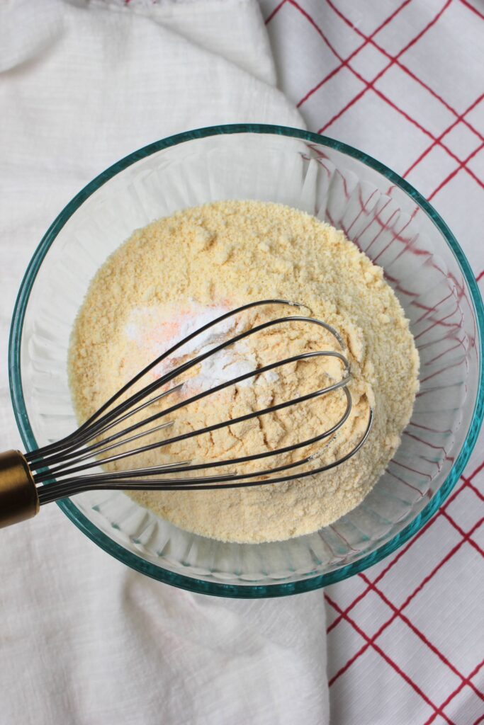 Whisking the dry ingredients in a glass bowl.