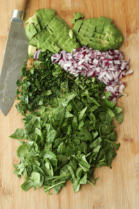 All of the ingredients have been chopped on a cutting board.