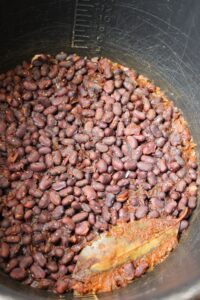 Finished black beans in the pressure cooker bowl.