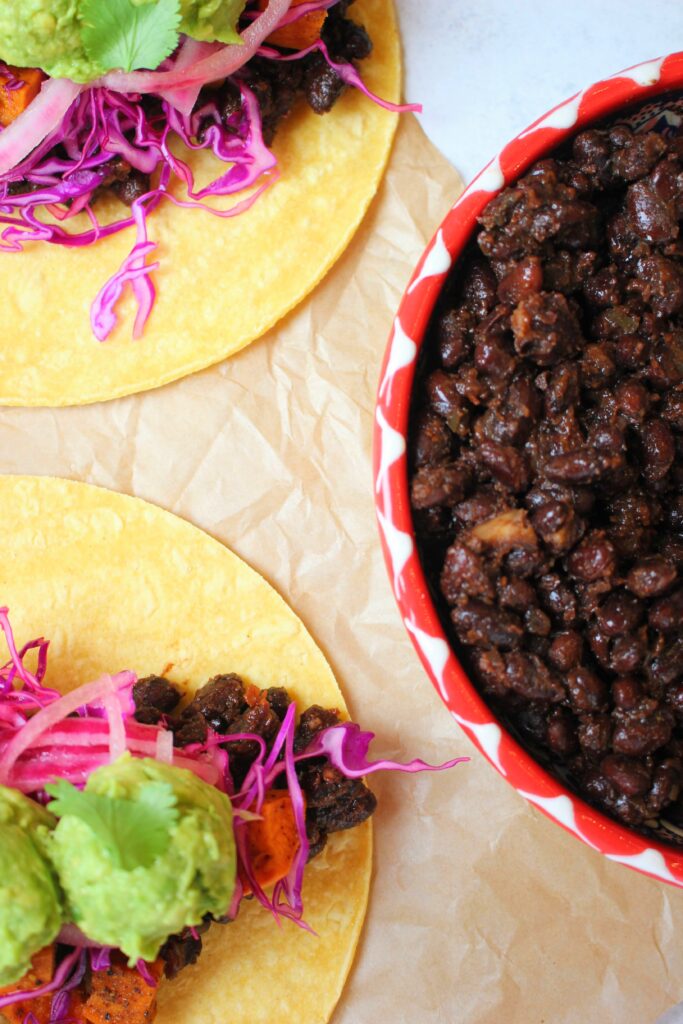 Tacos stuffed with these vegan spiced black beans.
