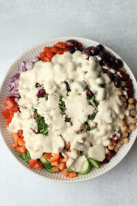 The vinaigrette has been poured over the salad.