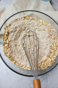 Mixing the dry ingredients in a large glass bowl.