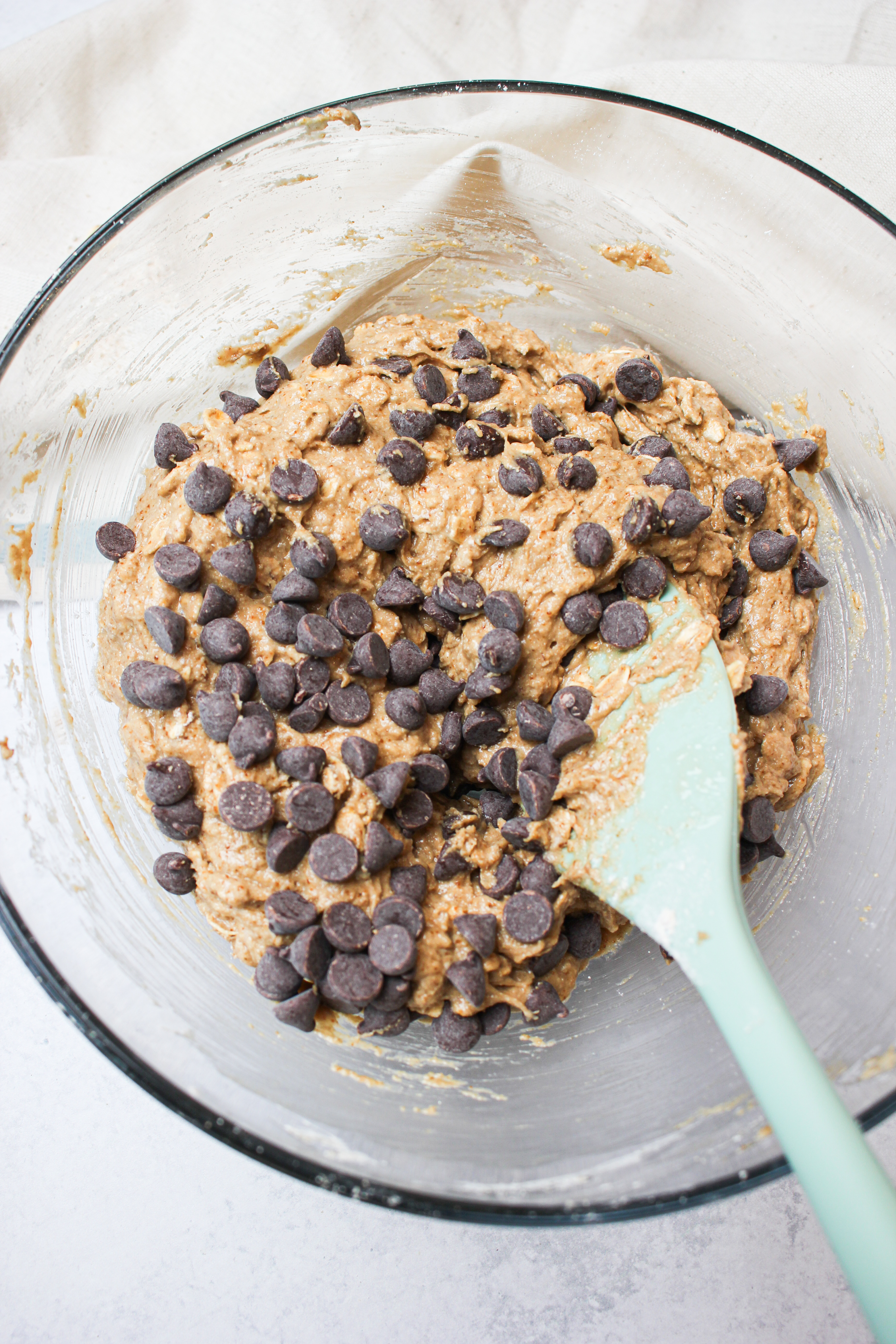 Folding in the chocolate chips into the batter.