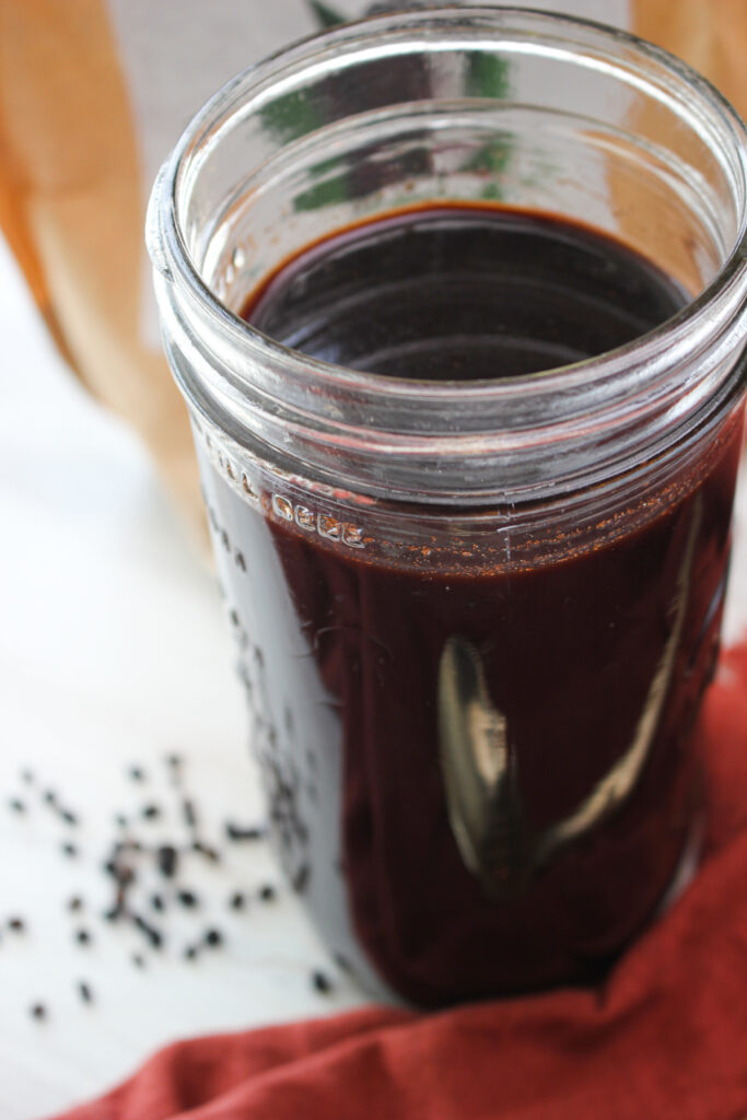 Just poured the finished elderberry syrup into a mason jar.