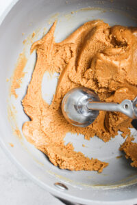 Scooping the dough with a cookie scoop.