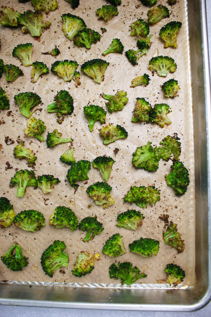The roasted broccoli on a pan fresh out of the oven.