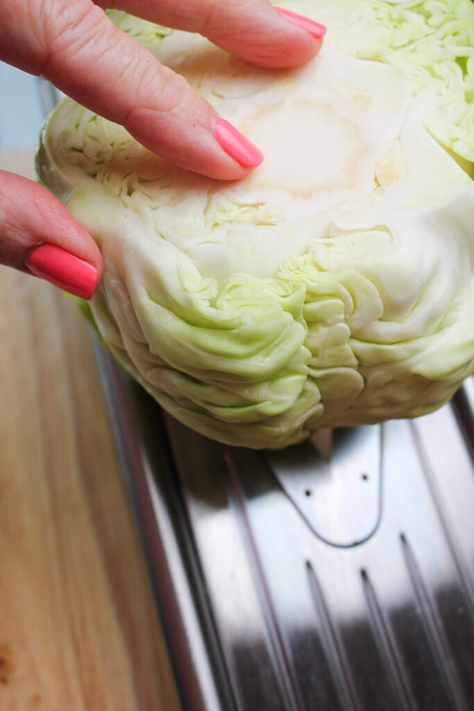 Slicing the cabbage into thin pieces.