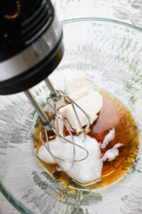 Blending the first few wet ingredients in a glass bowl.