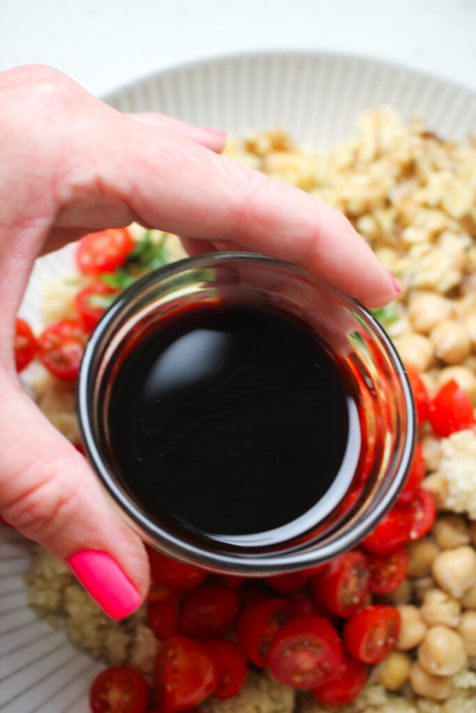 Pouring balsamic vinegar over top.