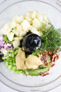All of the ingredients needed to make this dip in the bowl of a food processor. 