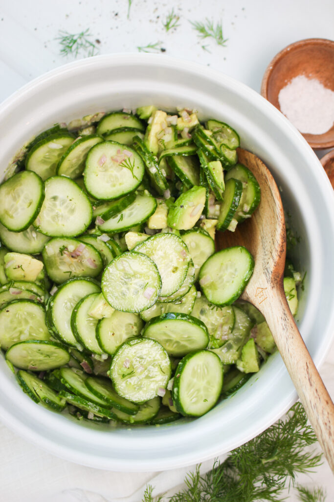 The vegan cucumber salad with fresh dill is ready to enjoy in a large serving bowl.