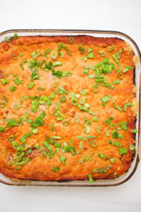 The hot enchiladas just came out of the oven. Just topped it with sliced green onion.