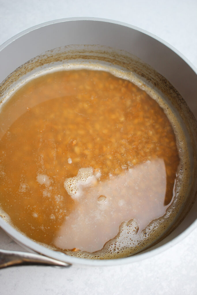 The farro cooking in a saute pan.