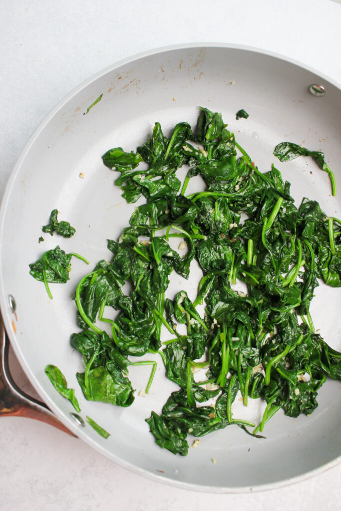 The sauteed spinach in a pan.