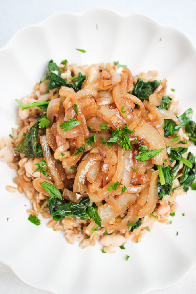 The farro and white bean dish is plated and ready to eat.