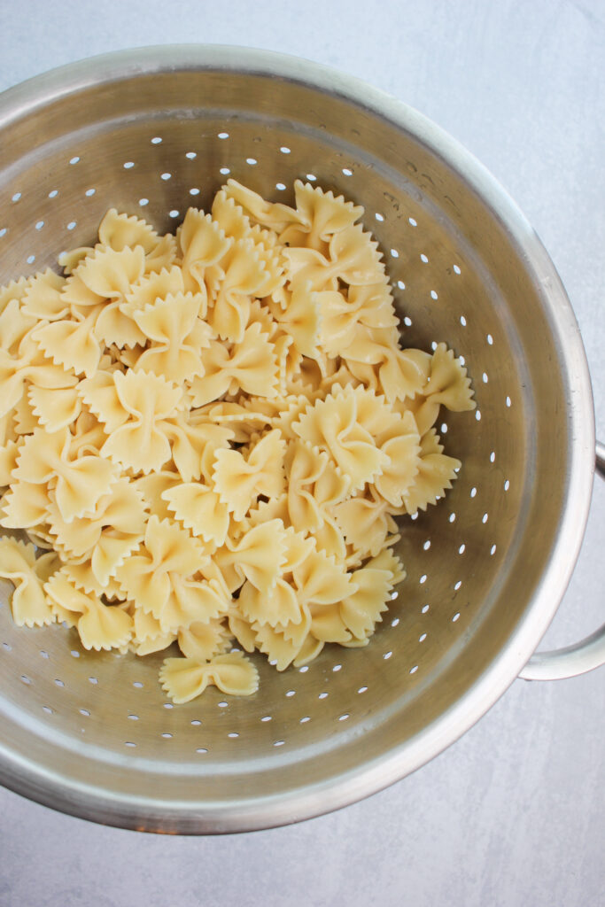 The cooked pasta drained in a colander, 