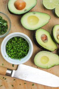 All of the produce has been cut up on a cutting board.