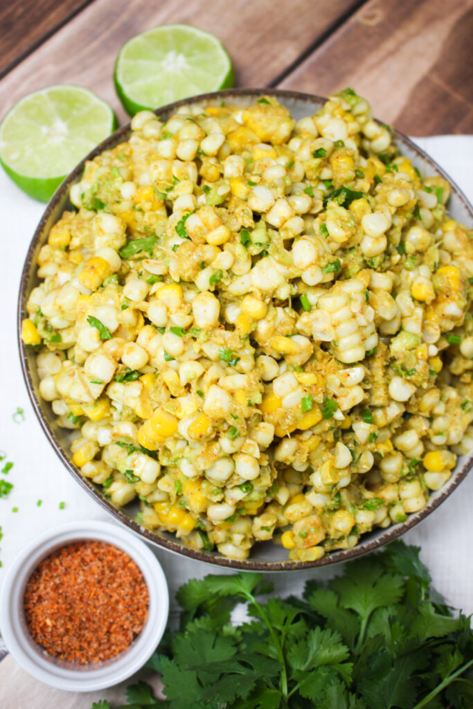 The vegan street corn guacamole salad is in a bowl and ready to be served.