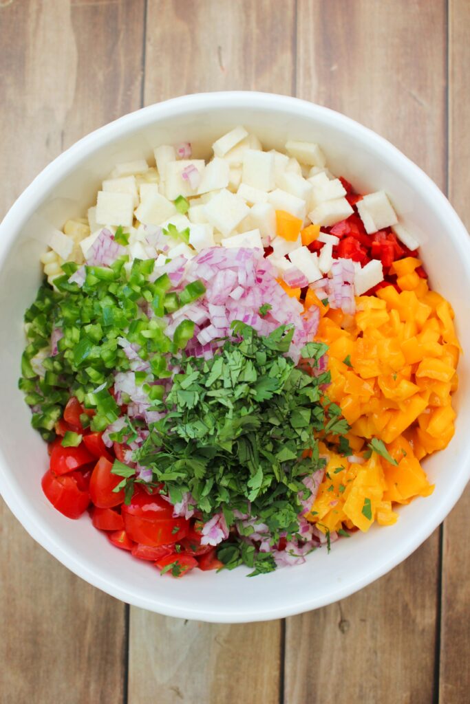 All of the ingredients of the salsa in a large bowl ready for the dressing,