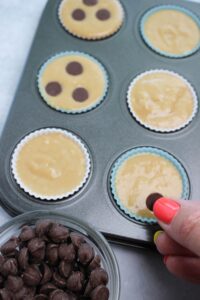 I am placing chocolate chips into the center of each cup.