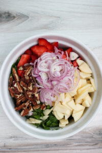 All of the ingredients in a bowl and ready for the dressing.