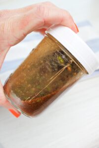 All of the ingredients in a mason jar. I am shaking the mason jar.