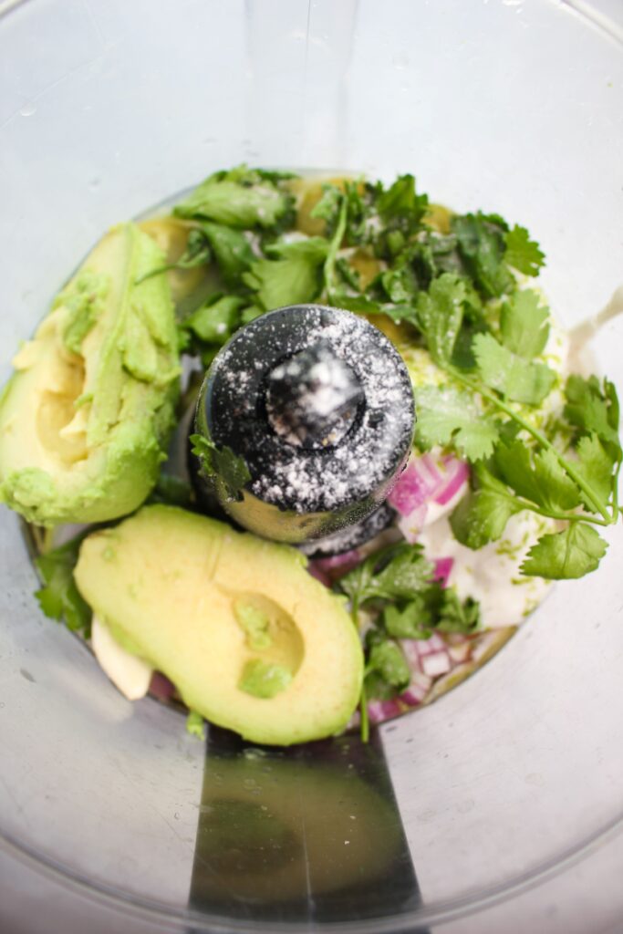 All of the ingredients in the bowl of a food processor.