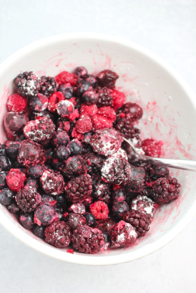 Mixing the berries in a medium bowl.