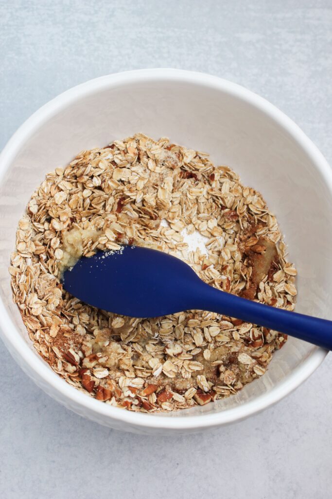 Mixing the oat topping ingredients together in a bowl.