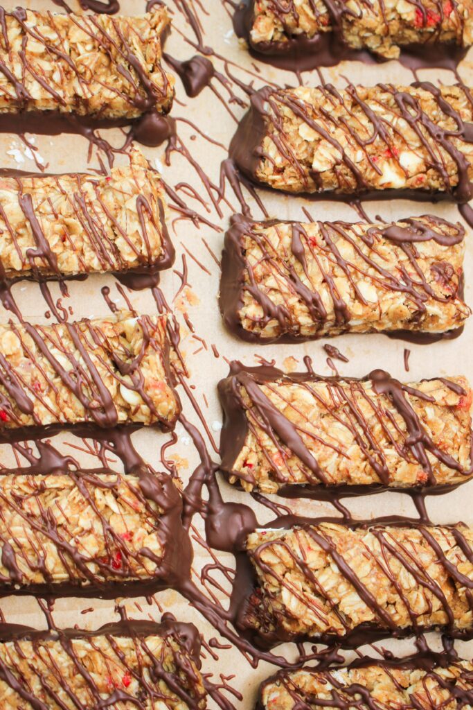 An up close picture of the granola bars layed out on parchment paper.