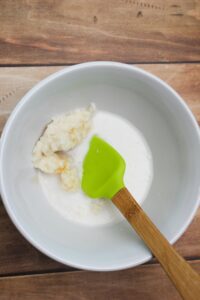 All of the ingredients for the glaze in a bowl with a spatula.