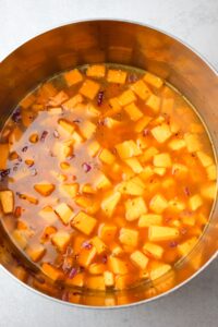 Step two includes adding the butternut squash and stock into the large bowl.