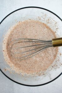 Mixing the main ingredients in a glass mixing bowl.