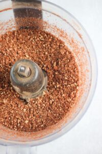 Pulsing the crust ingredients in a food processor. 